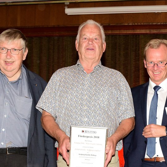 Diözesanpräses Reinhard Molitor (links) und Diözesanvorsitzender Norbert Frische (rechts) überreichen Manfred Haustermann die Auszeichnung der Hans-Tegeler-Stiftung.
